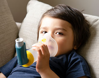 child with asthma inhaler